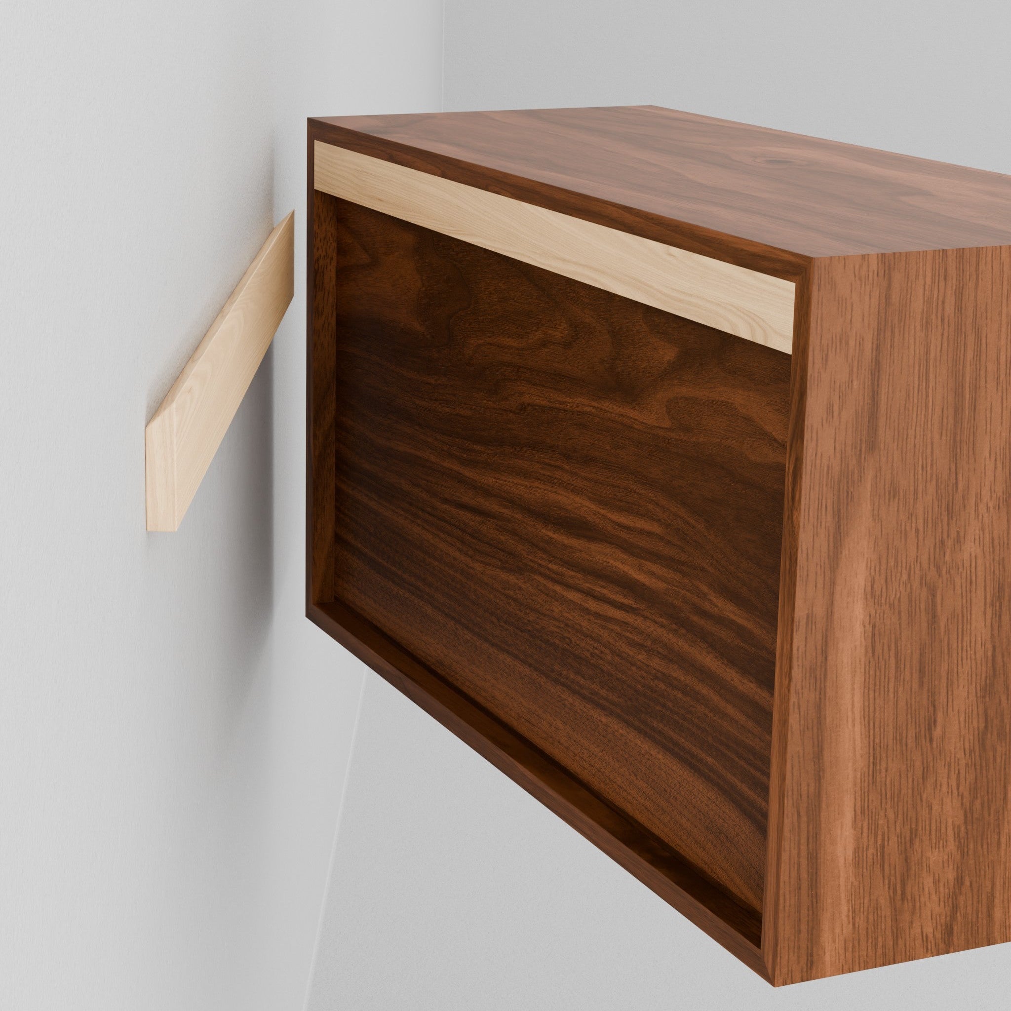 A person holds the Krovel Hardwood Floating Dresser, aligning its recessed back with a wall-mounted bracket to hang it securely using the included French cleat system.