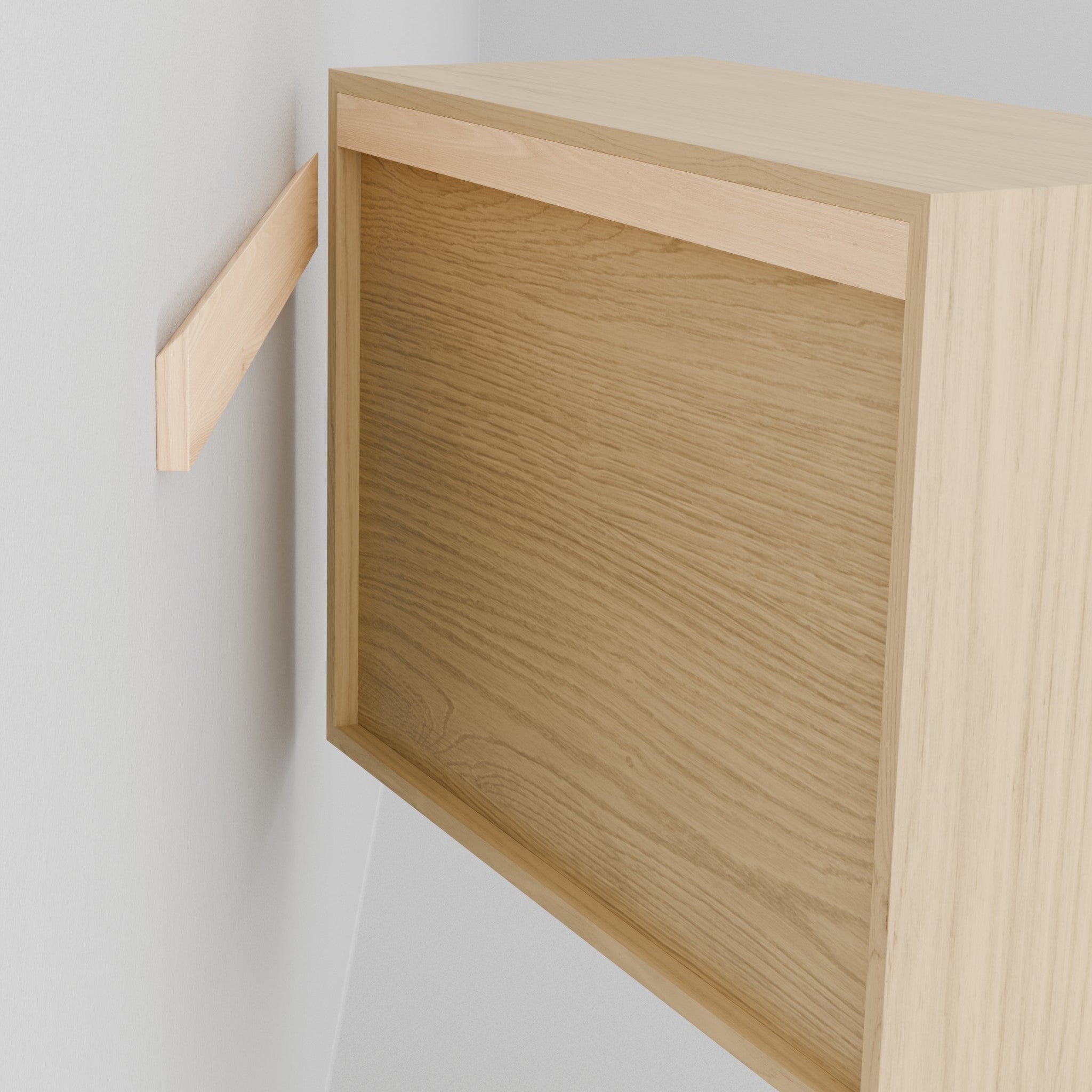 A Krovel Hardwood Floating Dresser is mounted on the wall using a wooden French cleat—one part attaches to the wall, while the matching piece is fixed to the dresser.