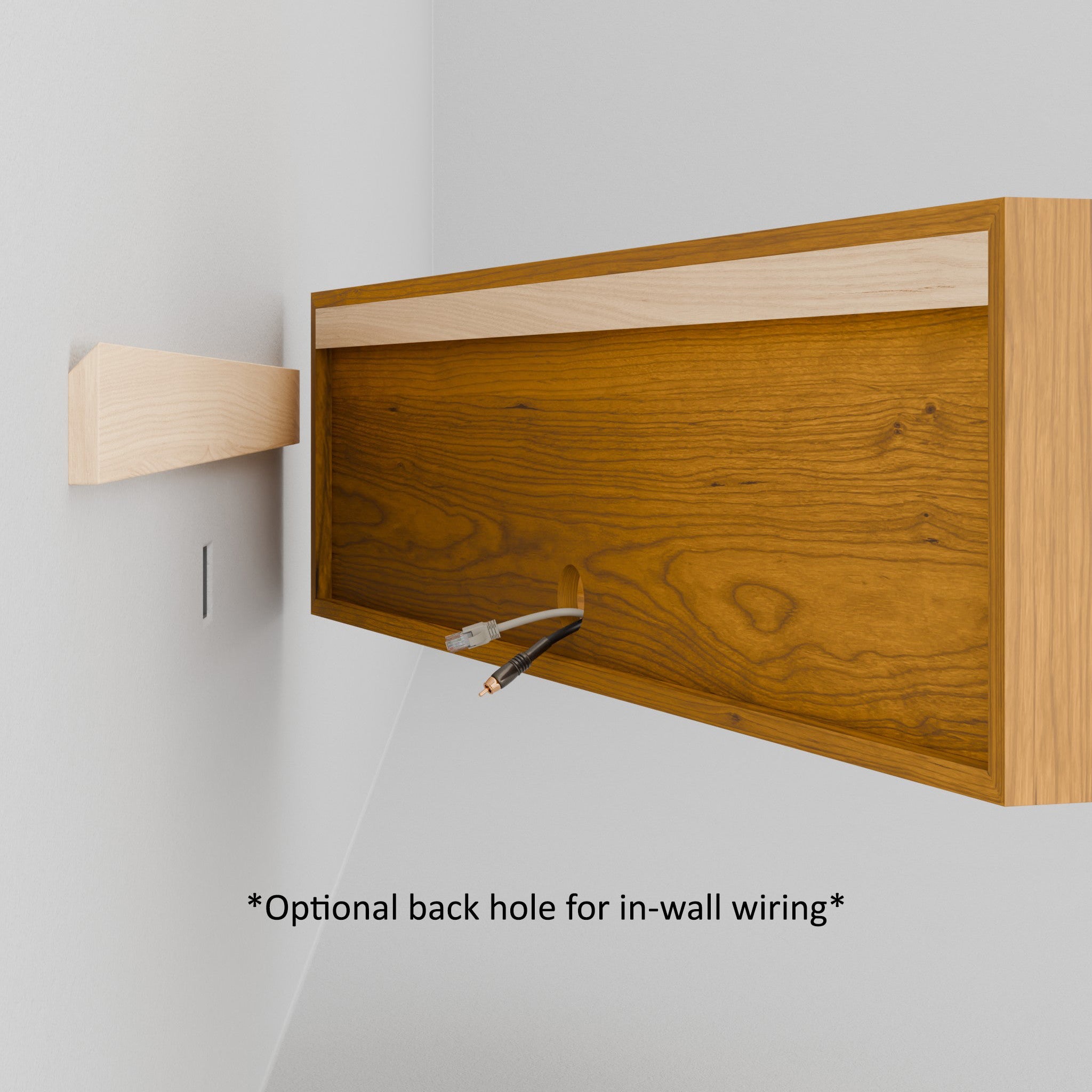 A person aligns the Krovel Hardwood Oversized Media Console, featuring a circular logo in one corner and a recessed back, with a wall cleat for mounting on a white wall.