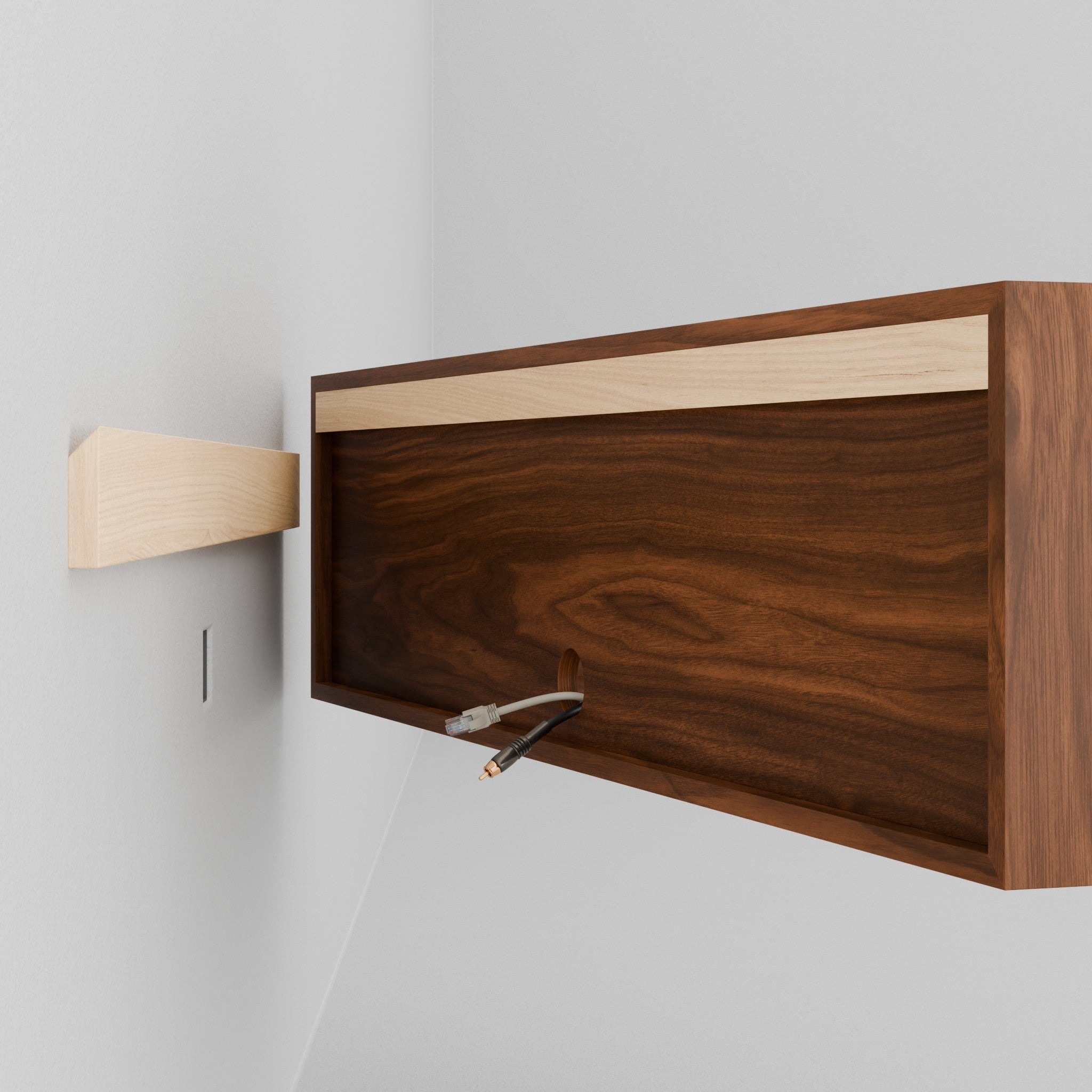 A person in a beige outfit is installing an Oversized Media Console Table in Walnut by Krovel onto a wooden bracket using a French cleat attached to a blue wall. The console's walnut finish adds elegance and contrast to the vibrant backdrop.
