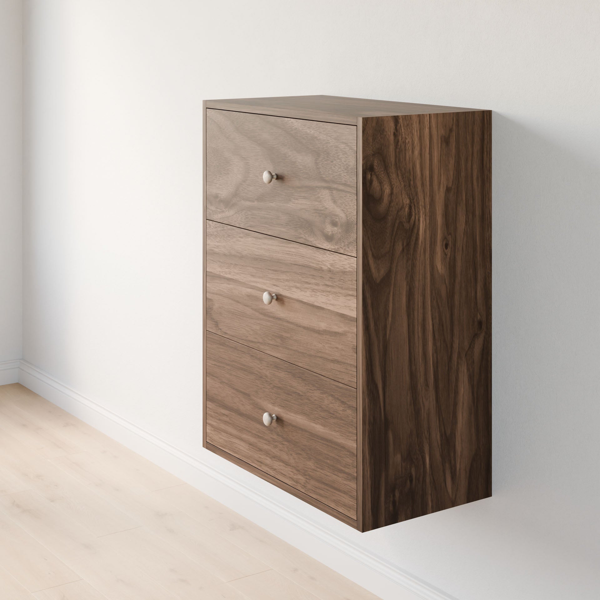 The Maine Made Closet Drawers by Krovel Furniture Co. is a wall-mounted dresser crafted from premium cabinet plywood, with three drawers featuring round metal knobs and a natural wood grain pattern.