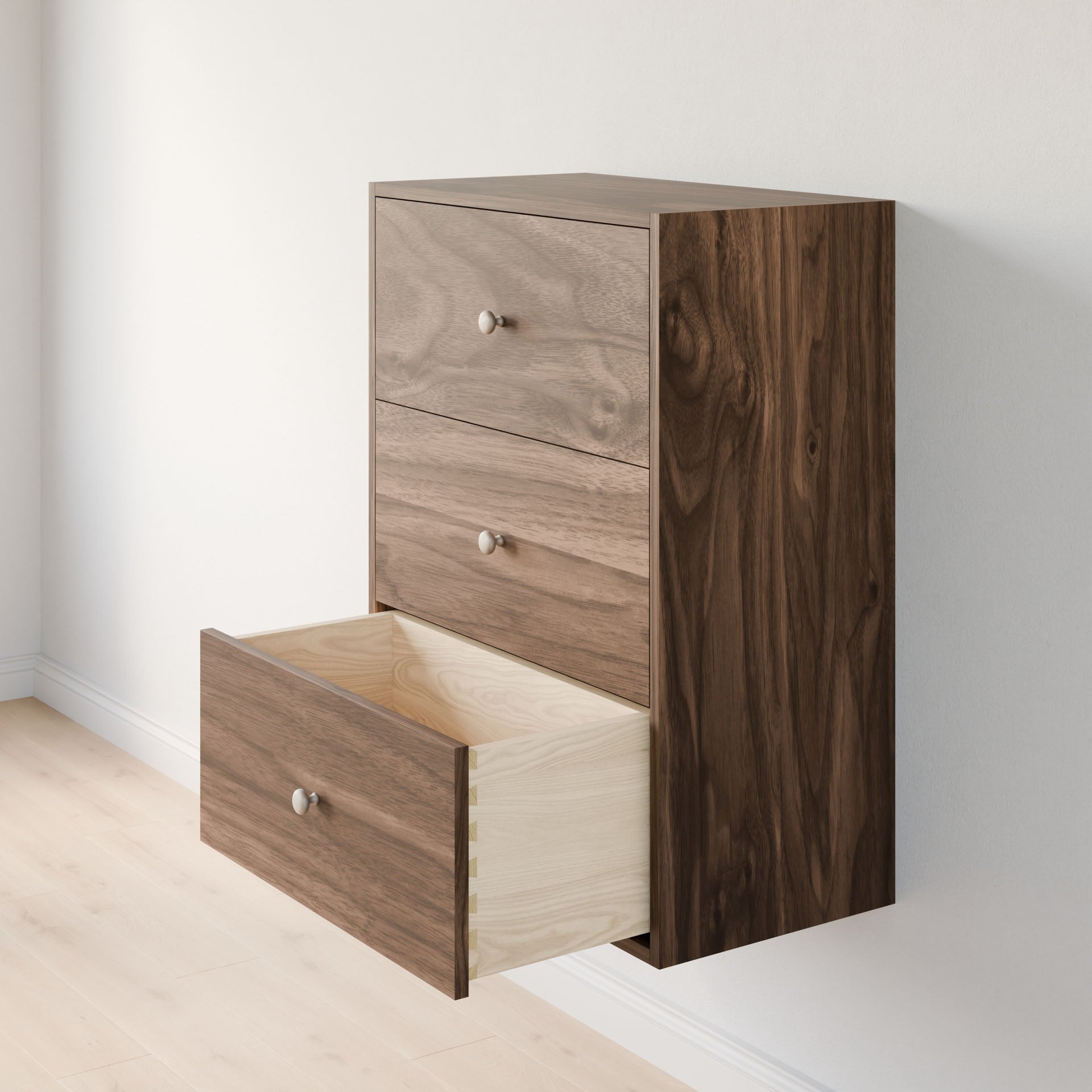 The Maine Made Closet Drawers by Krovel Furniture Co. is a modern wall-mounted dresser with three drawers, crafted from premium cabinet plywood in a natural wood grain finish, ideal for closet organization above light wood floors.