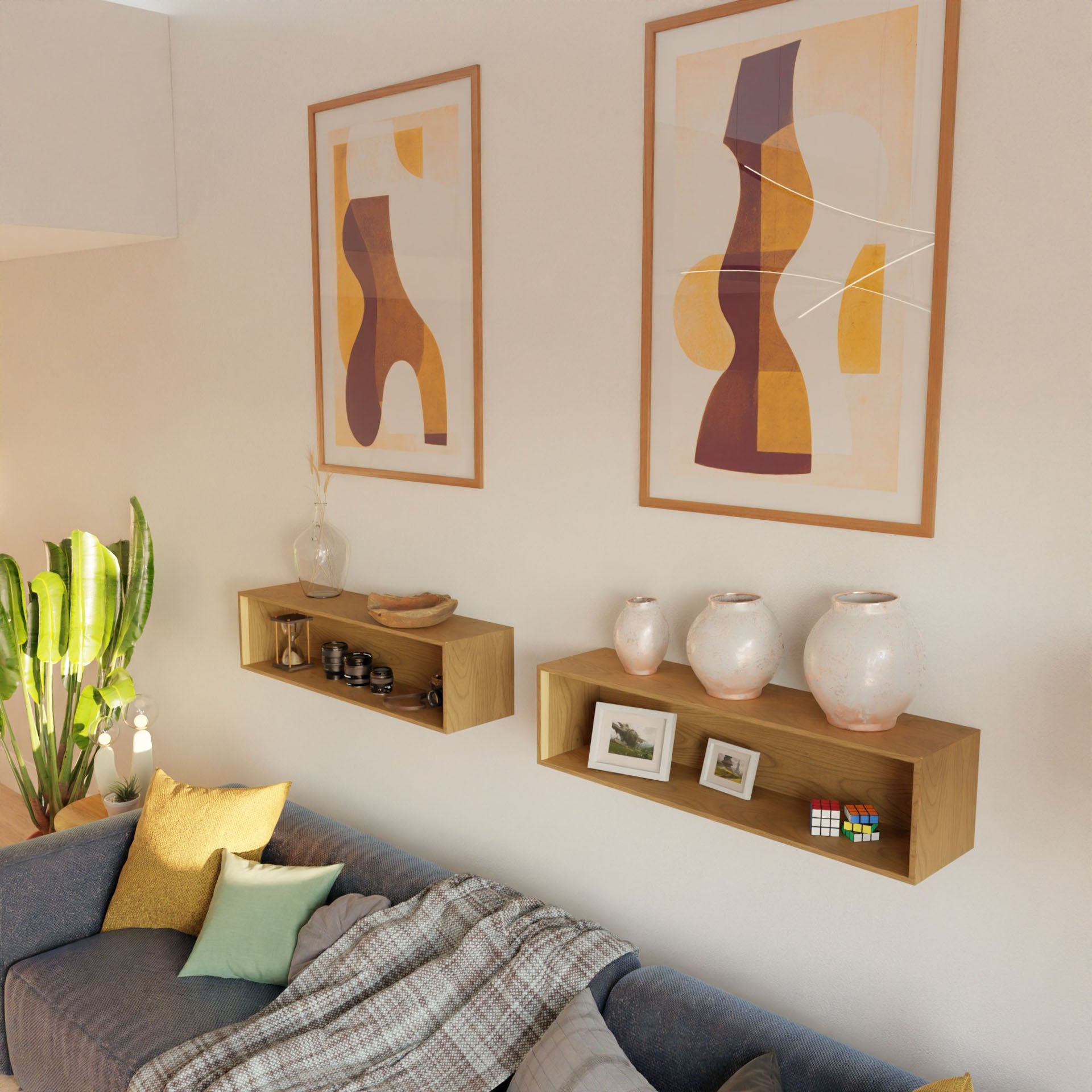 A cozy living room features a gray sofa with colorful pillows and a plaid throw, plus Krovel’s Hardwood Floating Display Case holding vases, framed photos, and a Rubik's cube, with abstract art and a tall green plant in the background.