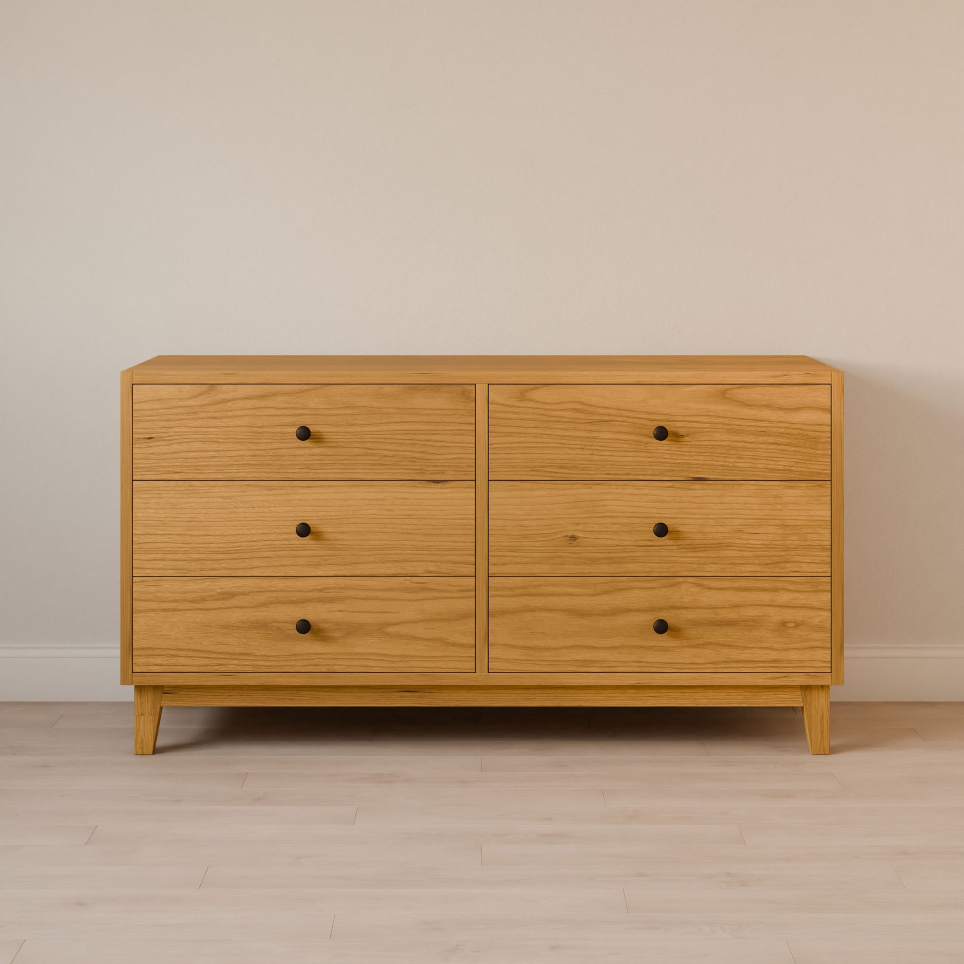 The Maine Made Six Drawer Dresser by Krovel Furniture Co. features six drawers with round black knobs, a simple modern design, and stands on short legs. Handmade in Portland, Maine from solid wood veneer.