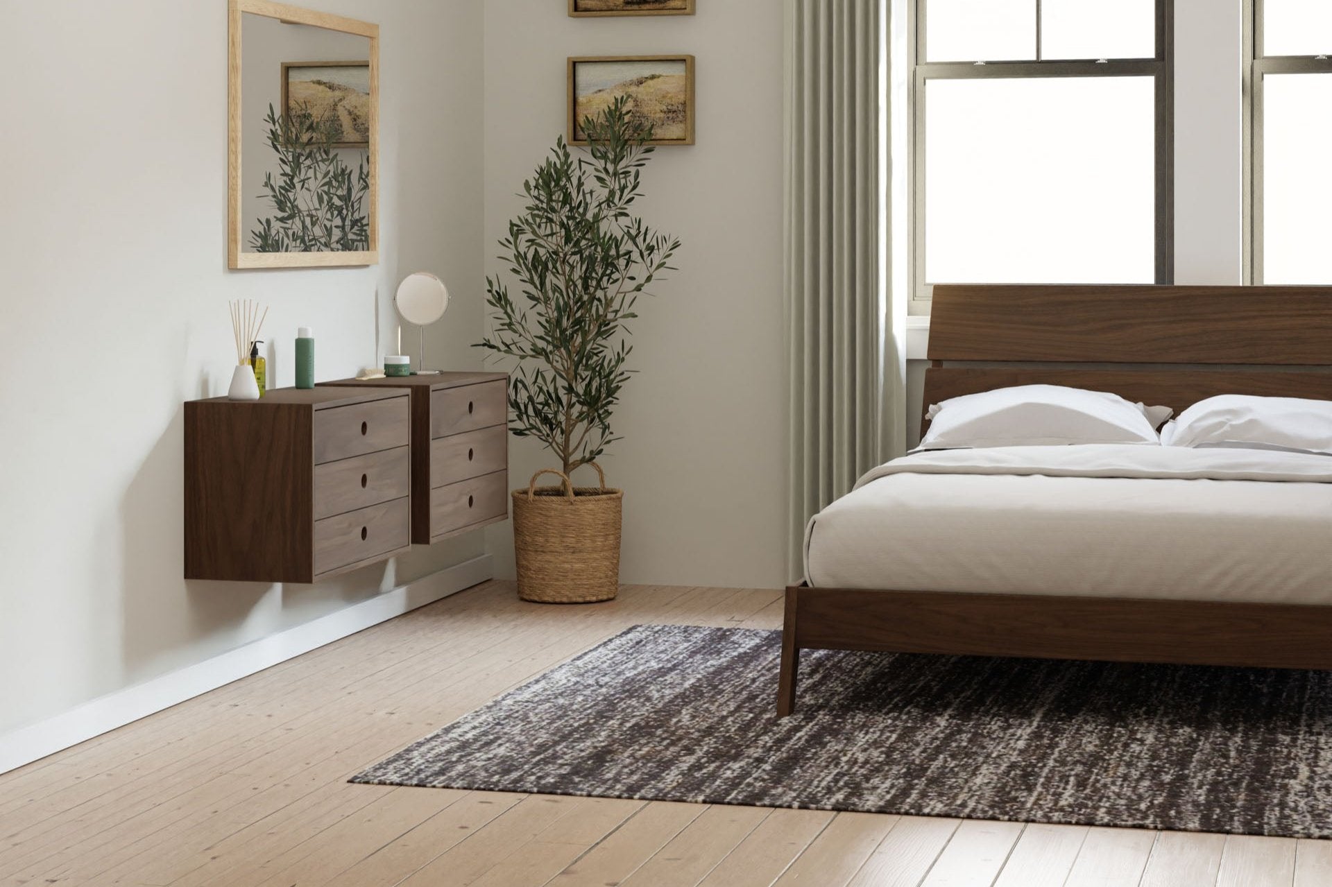 A minimalist bedroom with a wooden bed, a floating wooden dresser, and a potted plant. Neutral walls have framed art, and tall windows are covered with light curtains. A textured rug is on the wooden floor.