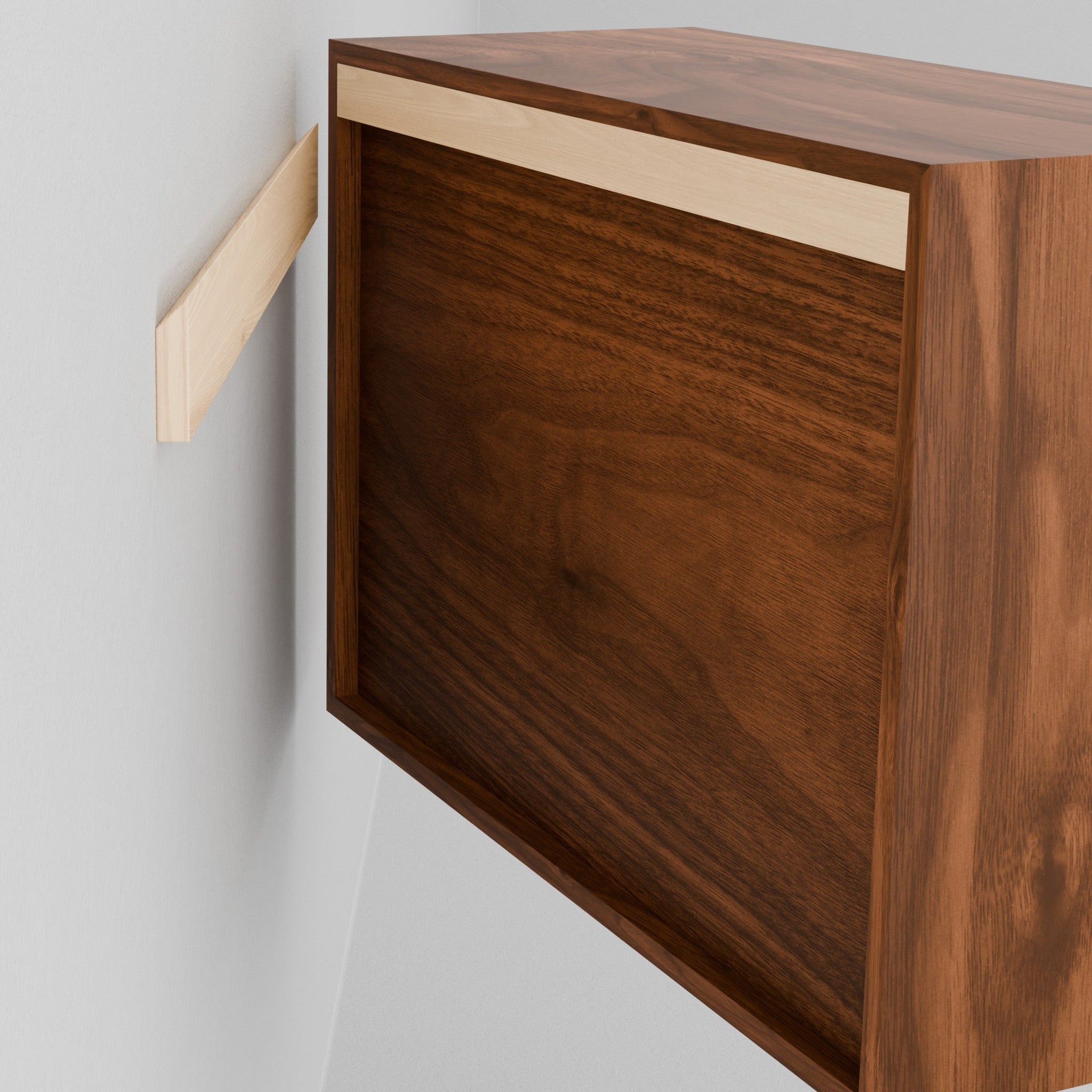 A person holds a Krovel Hardwood Floating Dresser near a wall-mounted wooden cleat, preparing to install the dresser as a floating unit.