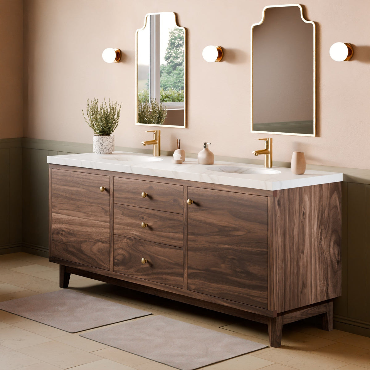 A modern double-sink bathroom vanity with a dark wood cabinet, white marble countertop, and gold fixtures, shown in a styled bathroom setting with two mirrors, wall sconces, and bath mats.