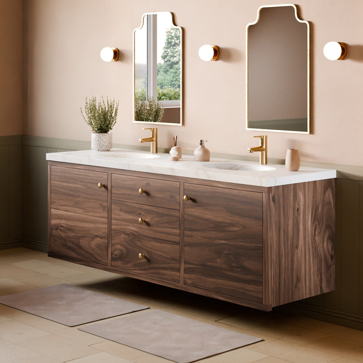 A floating double-sink bathroom vanity with a dark wood grain cabinet, white marble countertop, and gold faucets, shown in a styled bathroom setting with two mirrors, wall sconces, and bath mats.