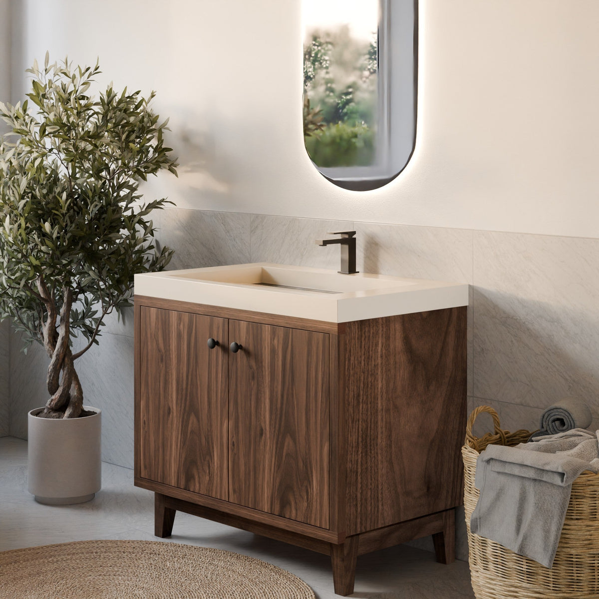 A modern bathroom vanity with a dark wood cabinet, a white rectangular sink, and a matte black faucet, styled in a bright bathroom setting with a potted plant, woven rug, and basket.
