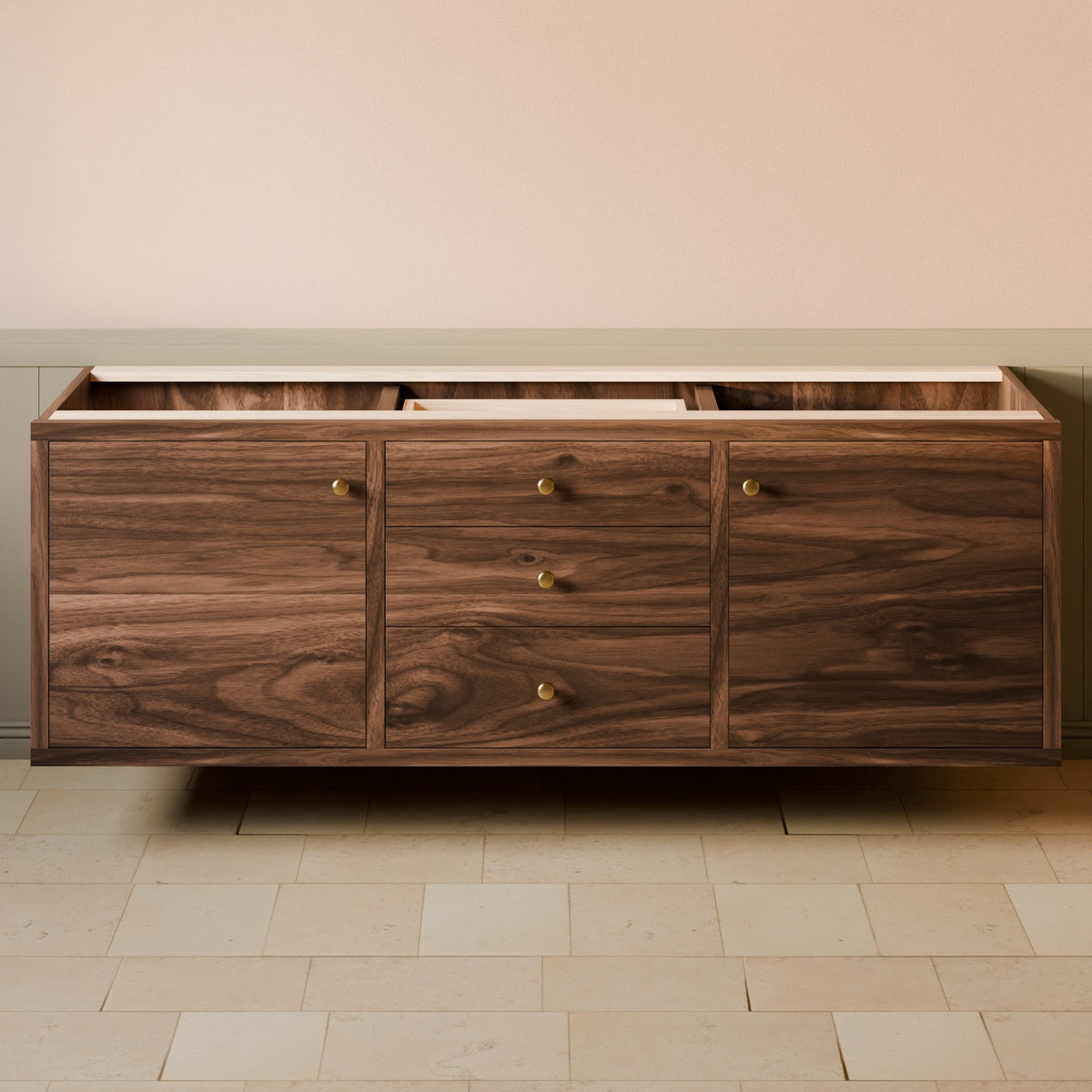 A floating wooden sideboard or credenza with three drawers and three cabinet doors, featuring a dark walnut wood grain finish and small brass knobs, set against a beige wall and light stone tile floor.#wood_walnut
