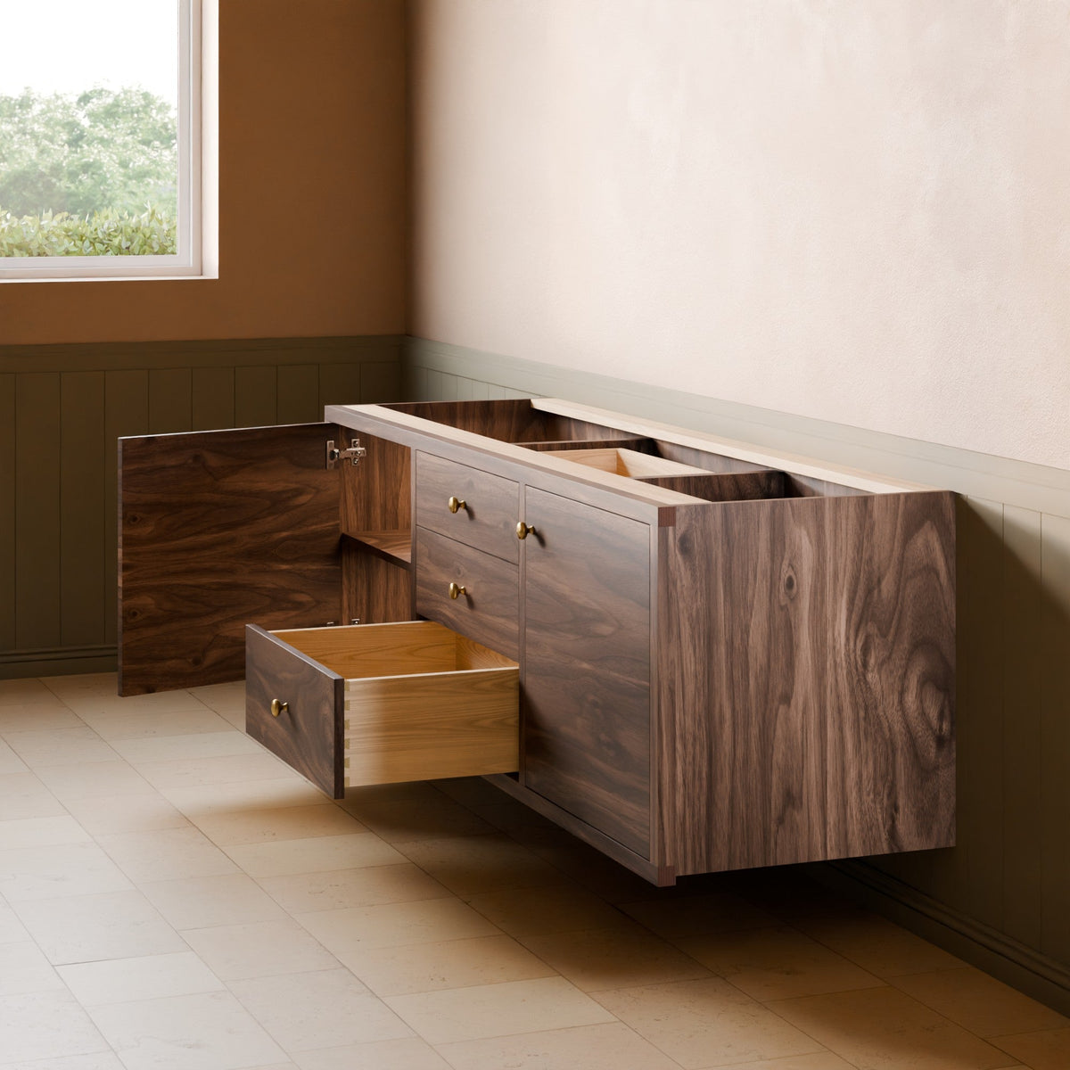 A floating wooden vanity or cabinet with dark walnut grain, shown in a styled room setting with one drawer open and another partially pulled out. The cabinet features brass handles and is mounted against a beige wall with green wainscoting.