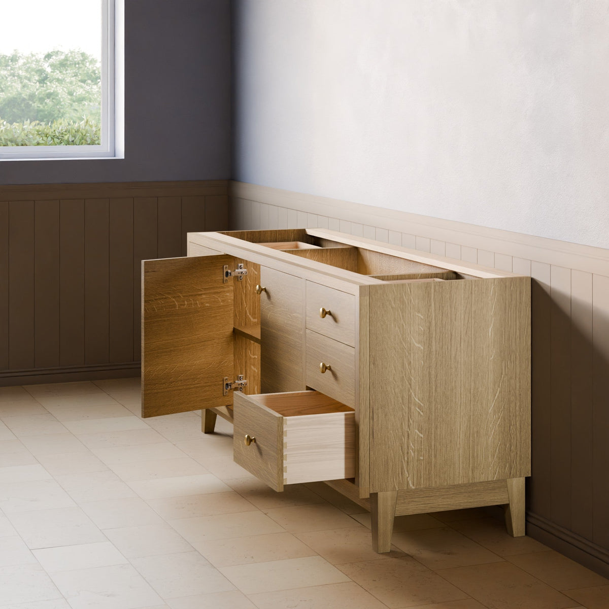 A light oak wood sideboard or credenza with brass handles, shown in a staged room setting with one cabinet door open and one drawer pulled out. The room features a gray upper wall, brown wainscoting, and light beige tile flooring.