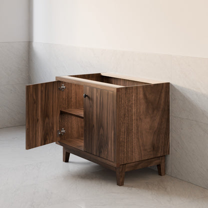 A mid-century modern wooden vanity cabinet with a dark walnut finish, featuring an open top shelf, two doors, and one open door showing the interior. The cabinet is set against a light beige tiled wall and floor.
