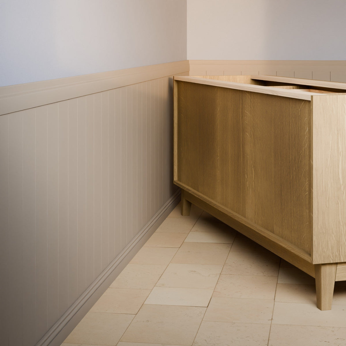 A light oak wood sideboard cabinet in a corner room with beige paneled walls and light stone tile flooring.
