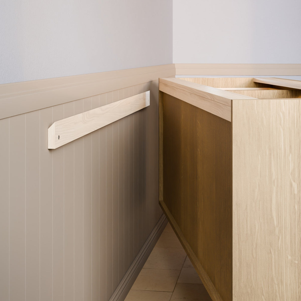 A light natural wood wall-mounted shelf or ledge installed on a beige paneled wall next to a wooden cabinet or counter in an indoor room setting.