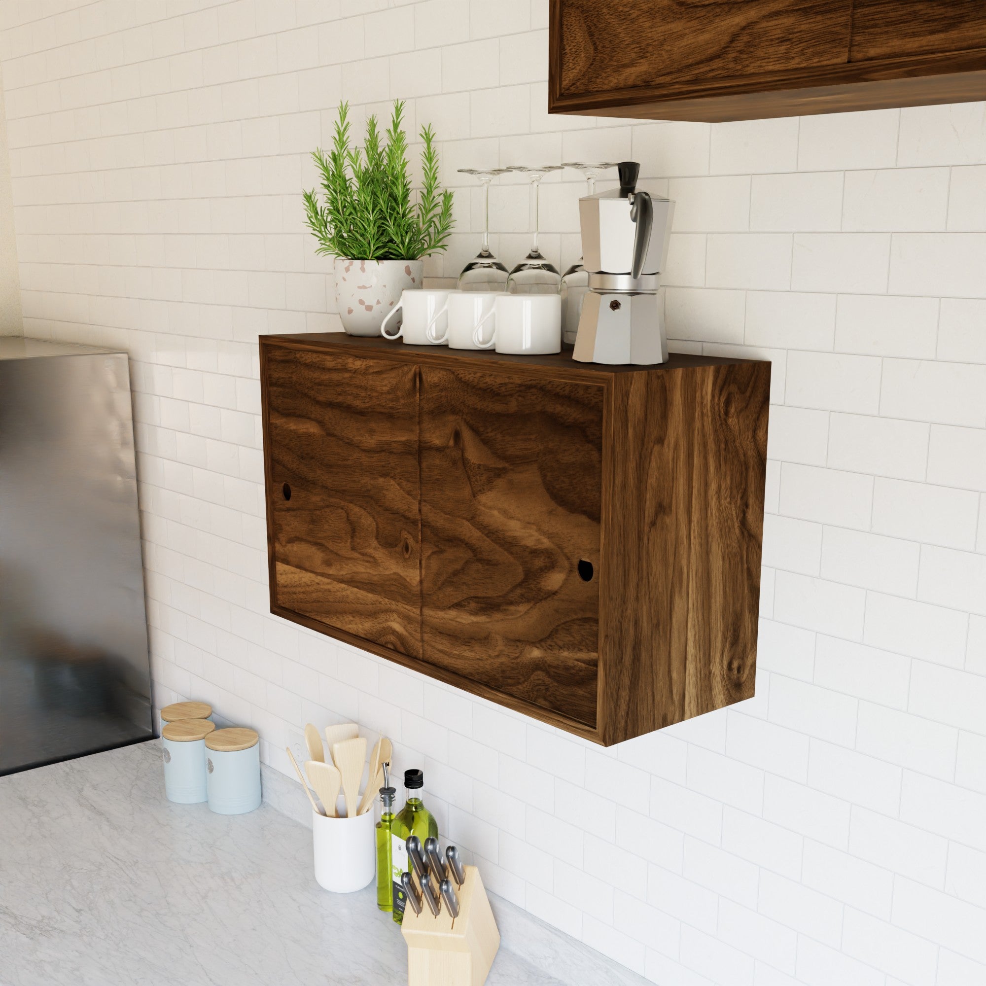 The Krovel Hardwood Cupboard Shelf mounts to the wall, holding cups, glasses, and a coffee maker by a potted plant. Below, a marble countertop keeps utensils, olive oil, canisters, and a knife block within easy reach.