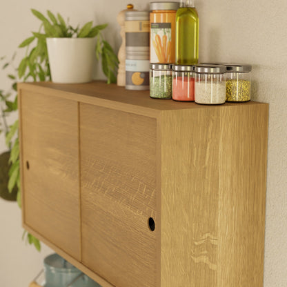 The Krovel Hardwood Cupboard Shelf neatly displays a potted plant, spice jars, a pepper grinder, olive oil, and a canister against a light-colored wall.