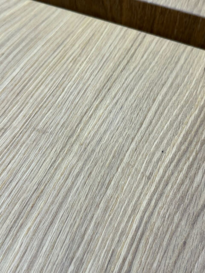 Close-up of a light-colored wooden surface crafted from solid White Oak, with visible grain patterns and a dark horizontal seam near the top—characteristic of Krovel Furniture Co. PAIR (2) White Oak Floating Nightstands - SECONDS.