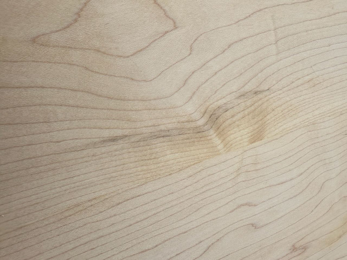 Close-up of the Maple Console Table - UNFINISHED by Krovel Furniture Co., showcasing its light-colored solid maple surface with visible grain patterns and a subtle indentation in the center.
