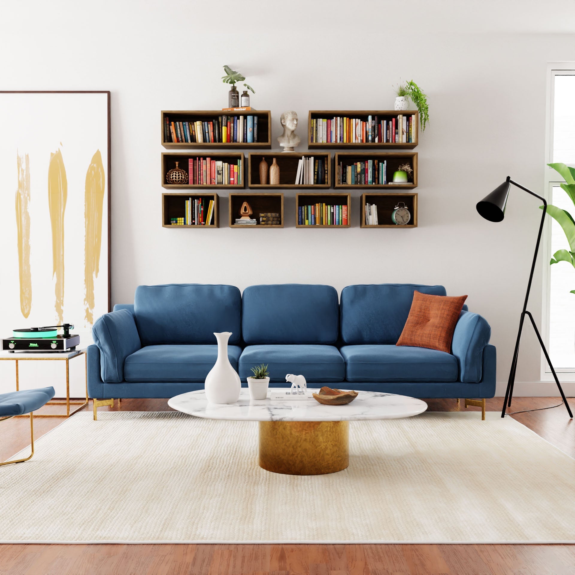 Modern living room with a blue sofa, brown pillow, white marble coffee table, floor lamp, abstract art, potted plants, and a Krovel Floating Bookshelf in White Oak—arranged atop a light rug and white oak flooring.