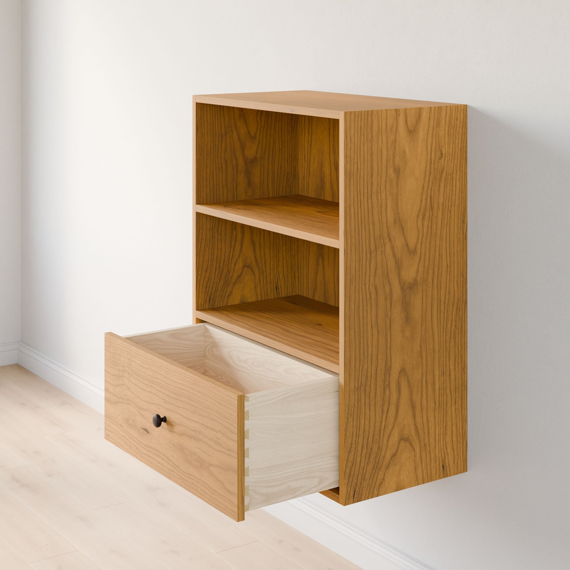 The Maine Made Closet Drawers by Krovel Furniture Co. is a wall-mounted wooden cabinet made from premium cabinet plywood, with two open shelves and a spacious lower drawer, shown against a light-colored wall and floor.