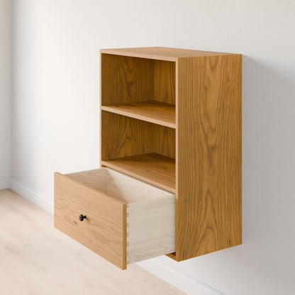 The Maine Made Closet Drawers by Krovel Furniture Co. is a wall-mounted wooden cabinet made from premium cabinet plywood, with two open shelves and a spacious lower drawer, shown against a light-colored wall and floor.