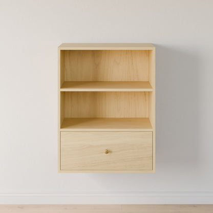 The Maine Made Closet Drawers by Krovel Furniture Co. is a light wood, wall-mounted shelf with two open compartments and a single drawer featuring a round brass knob—perfect for elegant closet organization against white walls.