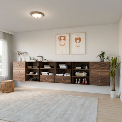 A bright, minimal living space features Krovel Furniture Co.’s Maine Made Closet Drawers crafted from premium cabinet plywood, neatly storing clothes and shoes. Abstract art prints, plants, a rug, and a wicker basket complete the inviting look.