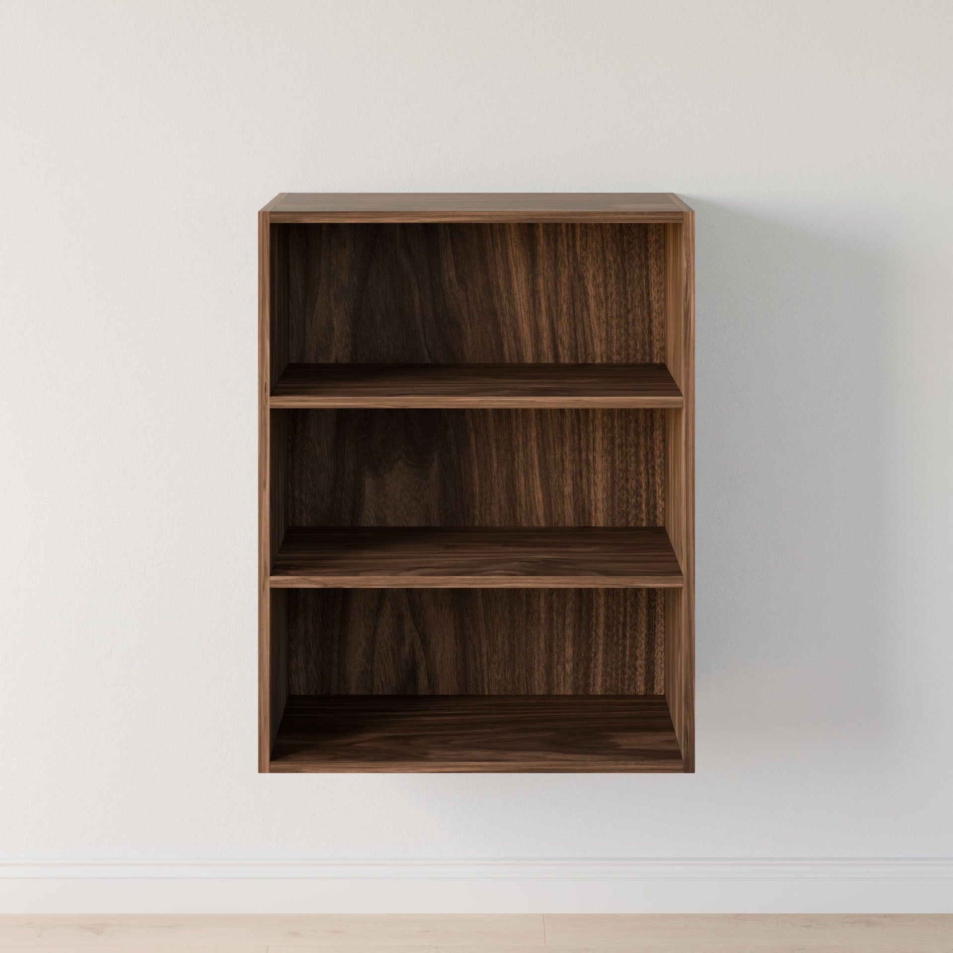 A compact, empty Maine Made Closet Shelves by Krovel Furniture Co. with three shelves is mounted on a plain white wall above a light-colored floor.