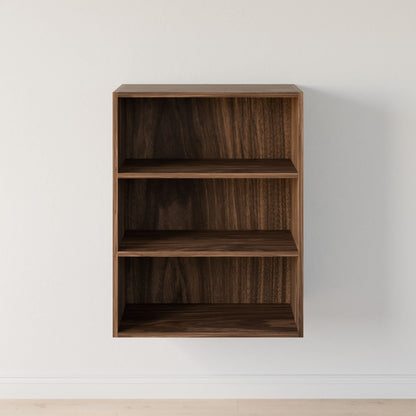 A compact, empty Maine Made Closet Shelves by Krovel Furniture Co. with three shelves is mounted on a plain white wall above a light-colored floor.