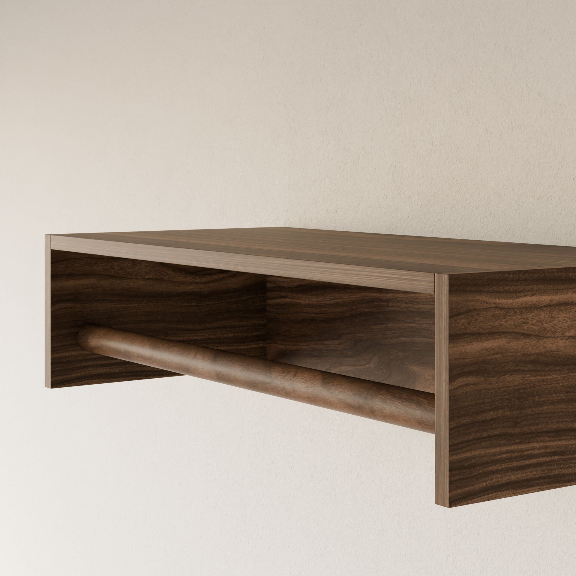 The Maine Made Closet Hanger by Krovel Furniture Co. is a minimalist plywood wall shelf with an open compartment and a horizontal rod—handmade in Portland, Maine—ideal as a modular closet hanger for light-colored walls.