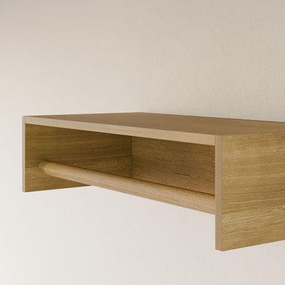 The Maine Made Closet Hanger by Krovel Furniture Co. is a minimalist wooden wall shelf with a horizontal rod beneath—ideal as a modular closet hanger—handmade from premium plywood and mounted on a light-colored wall.