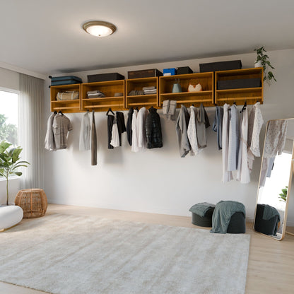 A tidy bedroom with sunlight features the Krovel Furniture Co. Maine Made Closet Hanger with Shelf, displaying hanging clothes and baskets on the floor, plus a full-length mirror, beige rug, and potted plant for a modern touch.