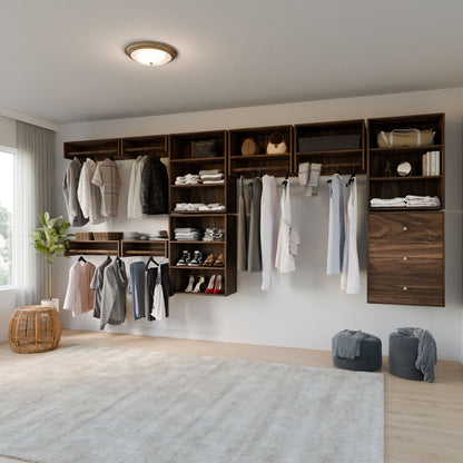 The Maine Made Closet Hanger with Shelf by Krovel Furniture Co. offers modern, organized storage for clothes, shoes, bags, and accessories in a dark wood finish. A large window brings in natural light and two laundry baskets rest on a soft beige rug.
