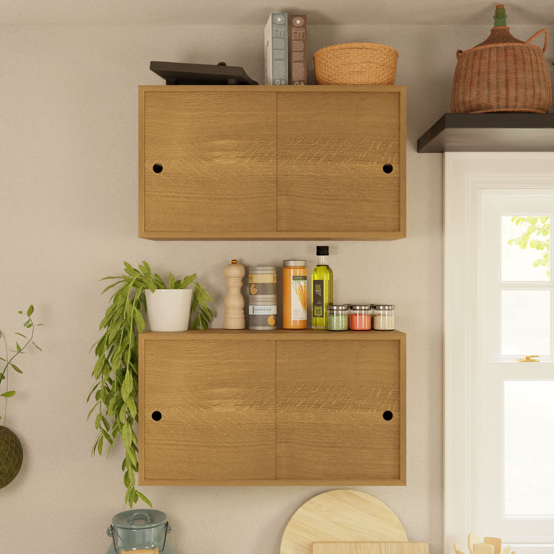 The Krovel Cupboard with Shelf in White Oak, mounted on the wall, holds cookbooks, a basket, spice jars, and olive oil bottles. A green plant elegantly drapes down the side of this unit as natural light streams through the window on the right.