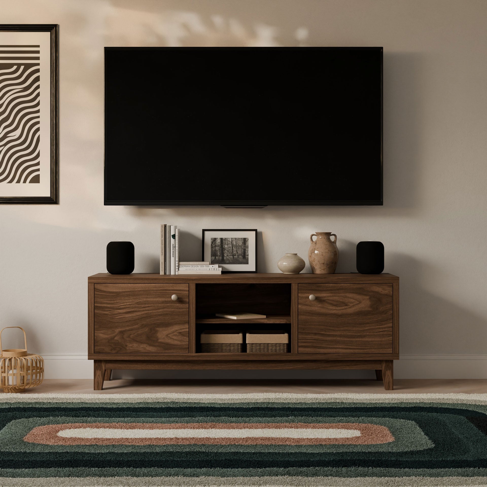 A contemporary living room includes a wall-mounted TV above the Krovel Furniture Co.s Double Door, Open Shelf Media Cabinet in Walnut. Customizable cabinets showcase decor and books, while a patterned rug adds texture to the floor and framed art enhances the nearby wall.