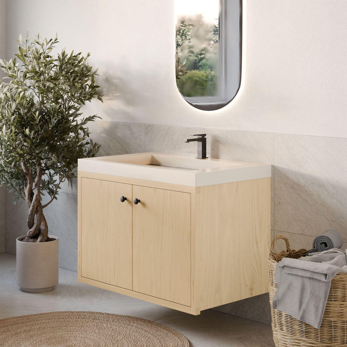 A modern bathroom featuring Krovel Furniture Co.'s Double Door Vanity in Maple, a rectangular sink with black faucet, oval backlit mirror, potted plant, and wicker basket with towels on a marble-tiled floor.