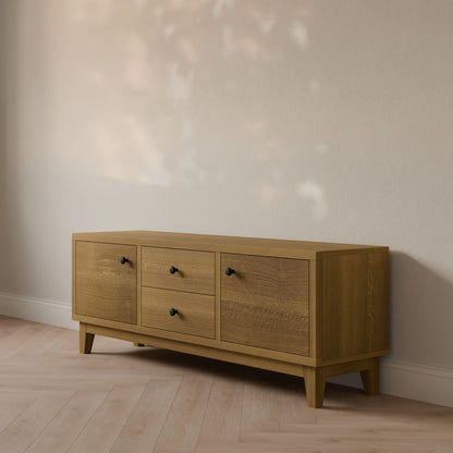 The Maine Made Double Drawer, Double Door Media Cabinet by Krovel Furniture Co. features ample storage with double drawers and doors, and its customizable design looks stunning in sunlit spaces with neutral walls and light wood floors.