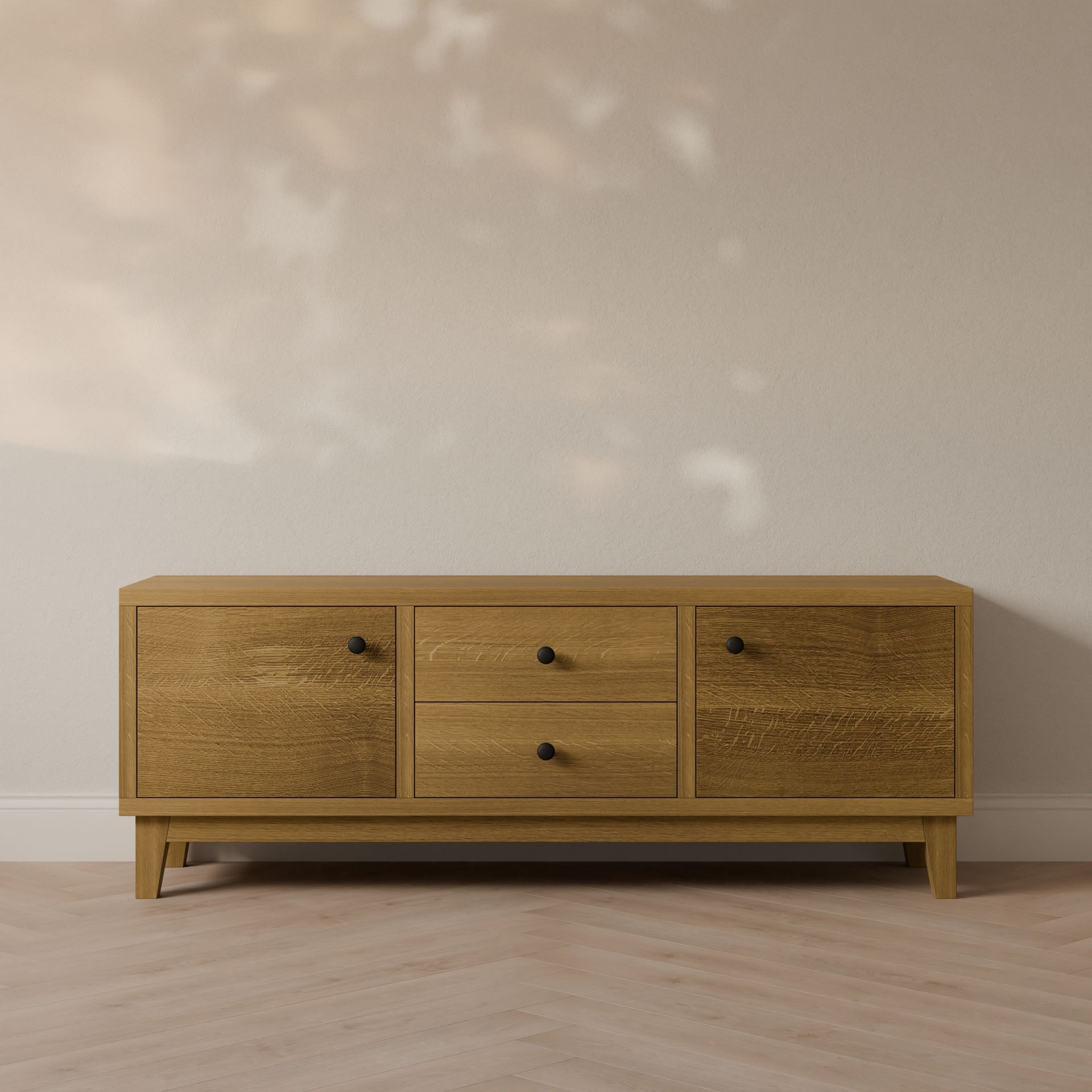 The Maine Made Double Drawer, Double Door Media Cabinet by Krovel Furniture Co. features two cabinets and central drawers. Handmade in Portland, Maine, it brings elegance and customization to any room with its artisanal woodwork.