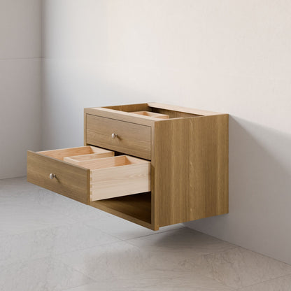 The Maine Made Double Drawer, Open Shelf Vanity by Krovel Furniture Co. is a modern, wall-mounted unit featuring two partially open drawers with light wood interiors, set against a light wall above a tiled floor.