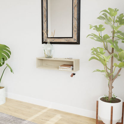 A modern entryway displays the Krovel Hardwood Entryway Organizer beneath a large mirror, topped with a glass vase of dried branches, keys, and sunglasses. Green potted plants flank each side against a white wall and light wood floor.