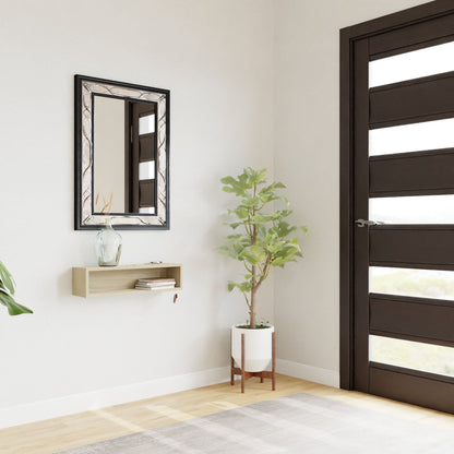 A modern entryway features a dark wooden door, potted plant, and the Krovel Hardwood Entryway Organizer with decor items. A decorative framed mirror hangs above, complementing light walls and a wooden floor.