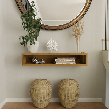 The Krovel Hardwood Floating Console Table displays books, silver decor, a potted plant, and dried wheat in glass, with two woven baskets underneath and a large round mirror above for a timeless mid-century modern style.
