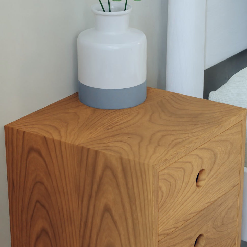 A white ceramic vase with a gray band sits on the Krovel Hardwood Triple Floating Nightstand, which features two drawers and a natural wood grain pattern.