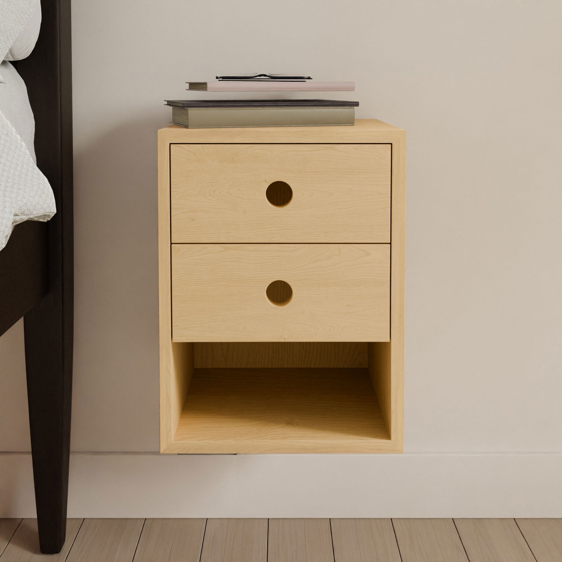 The Krovel Hardwood Triple Floating Nightstand is a handmade solid hardwood piece with three drawers featuring circular cutout handles, an open shelf below, and space on top for books and glasses.