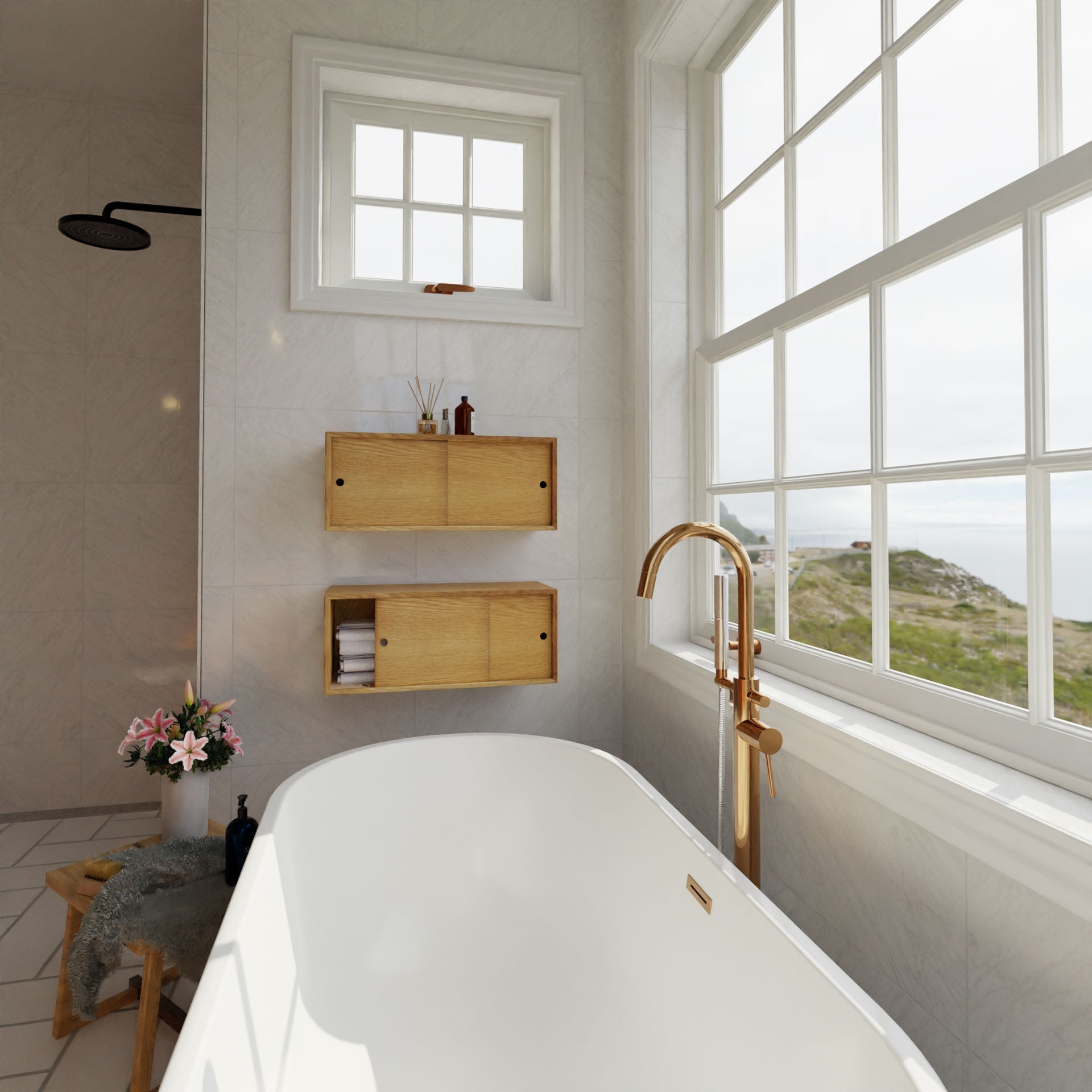 A modern bathroom showcases a freestanding white tub with a gold faucet near a large window. The Krovel Floating Storage Cabinet in White Oak and wooden shelves hold rolled towels and toiletries. A dark showerhead is visible, while flowers decorate a stool nearby. The window overlooks greenery and hills.