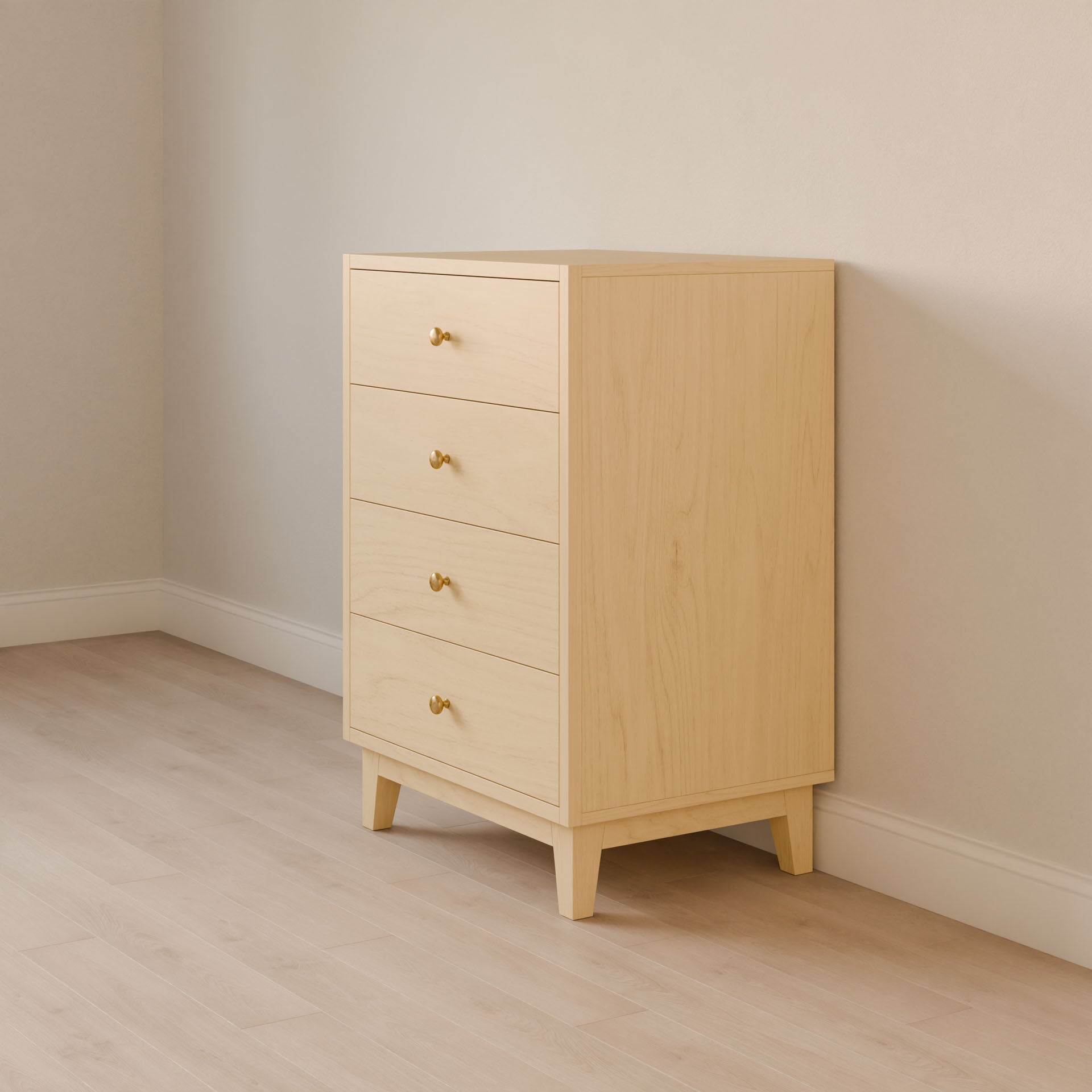 The Four Drawer Dresser in Maple by Krovel Furniture Co. stands against an off-white wall on light wooden flooring. This handmade dresser features a minimalist design with tapered legs and brass handles, showcasing the artistry of sustainable construction.