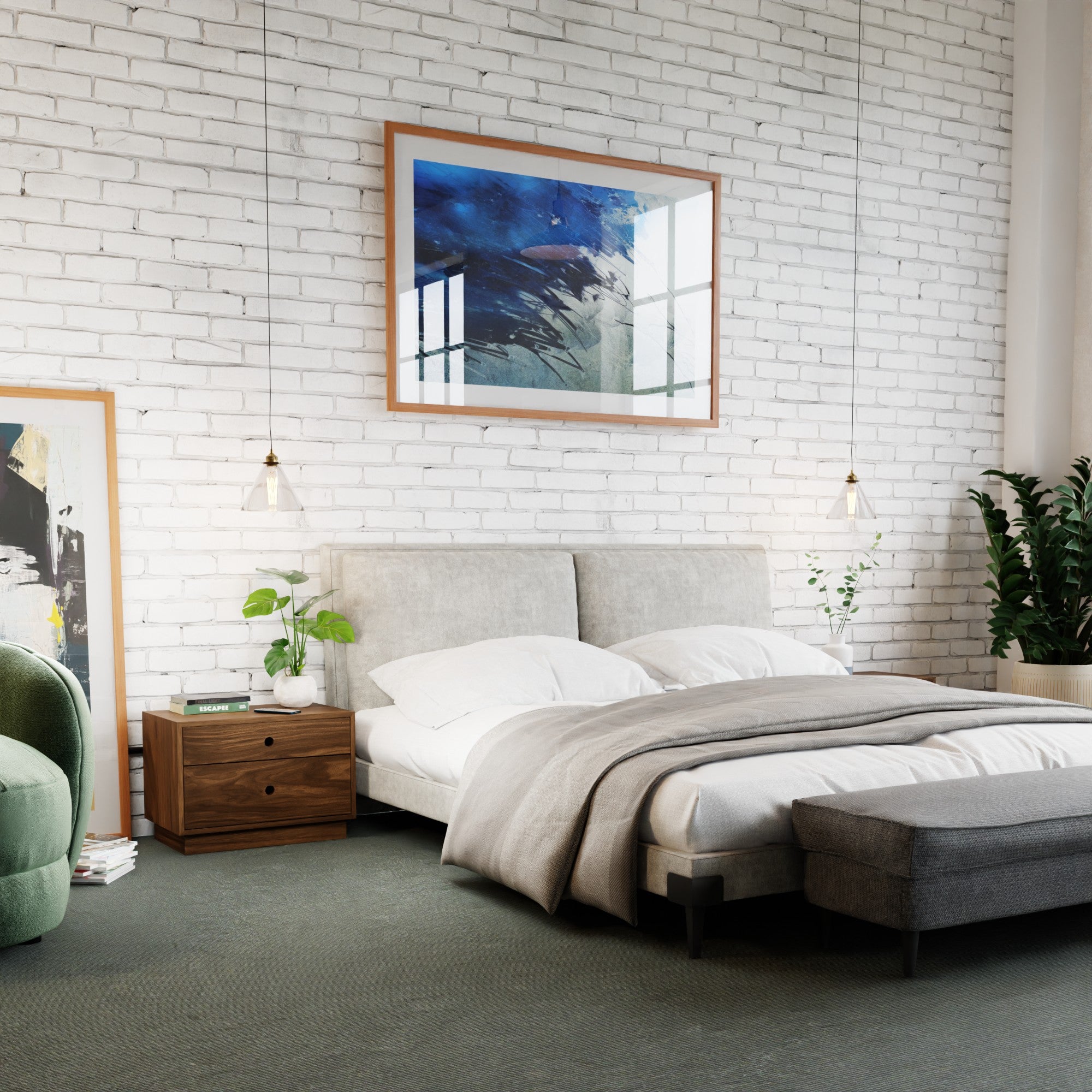 A modern bedroom features a white brick wall, gray upholstered bed, Krovel Hardwood Freestanding Nightstands with plants, green armchair, pendant lights, abstract art above the bed, and a gray bench at the foot.