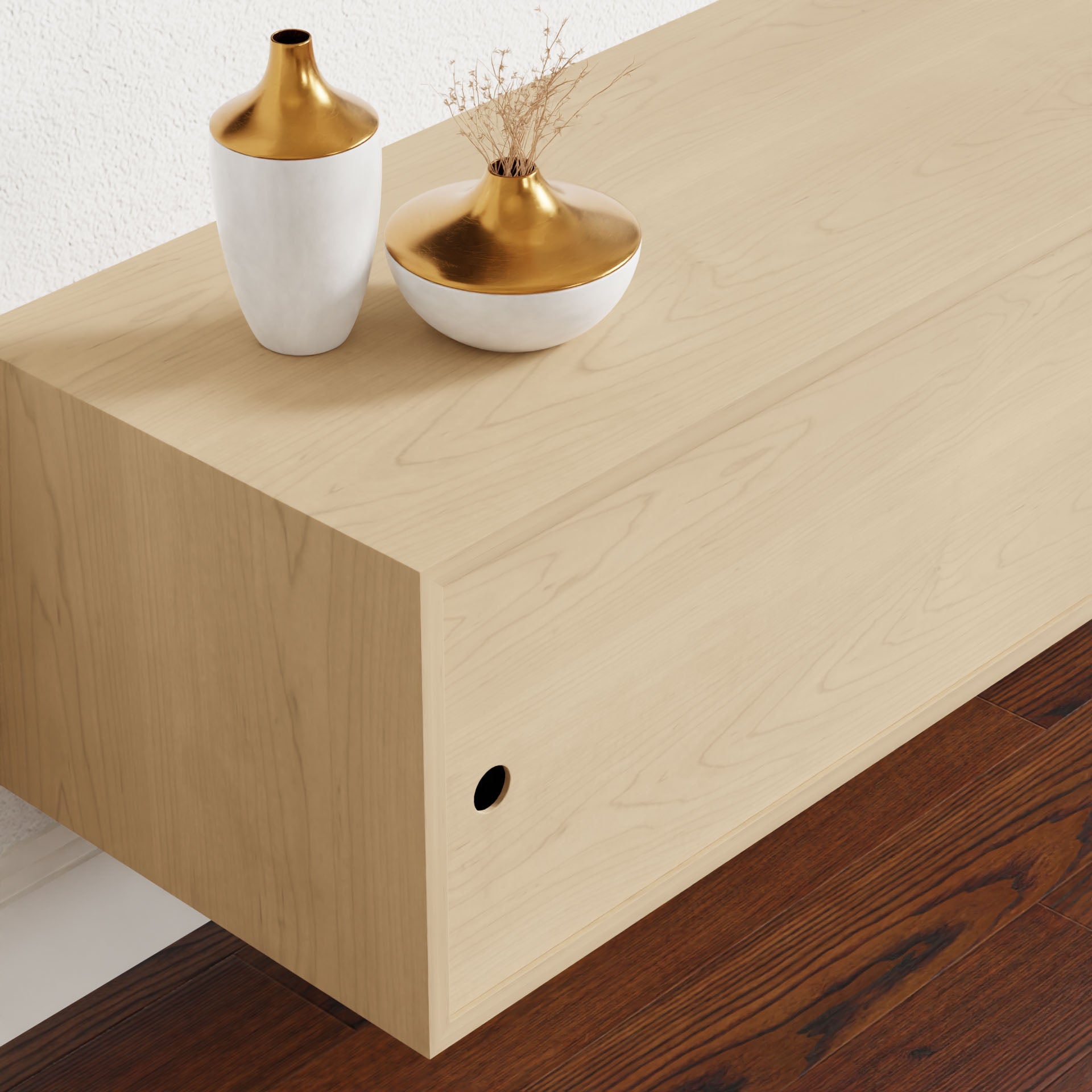 A minimalist wooden bench made of solid American Cherry with a VOC-Free Polymerized Linseed Oil finish sits on a dark floor. On it, a white vase with a gold top holds dried branches alongside a small white bowl with gold detailing, exuding elegance like Krovel's Oversized Media Console Table in Maple.