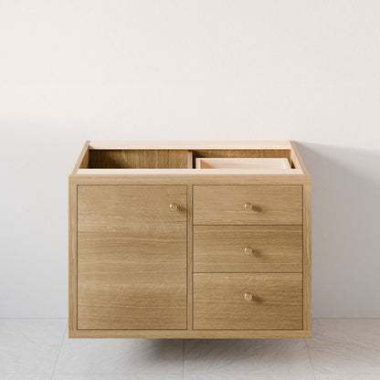 The Krovel Furniture Co. Maine Made Single Door, Triple Drawer Vanity, without countertop or sink, is shown against a plain light wall and white tile floor.